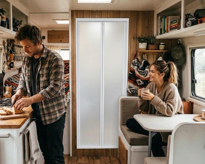 a man and woman cooking in a camper